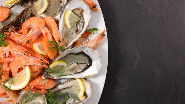 A platter of prawns and fresh oysters with lemon