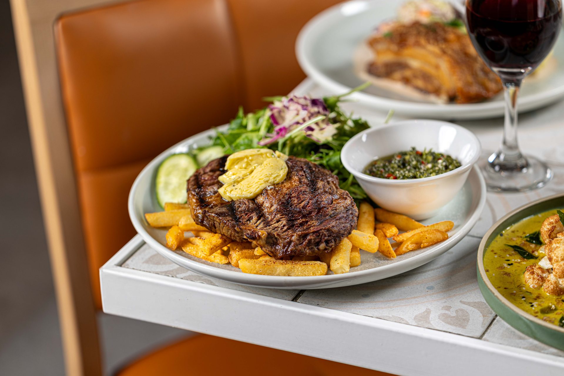Char-grilled steak with café de Paris butter, chips and garden salad at The Fairway