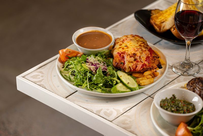Chicken parmigiana with chips and salad