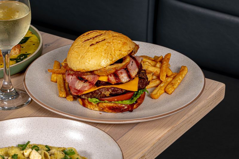 Stacked beef burger with bacon, cheese and chips at The Jack & Cleaver